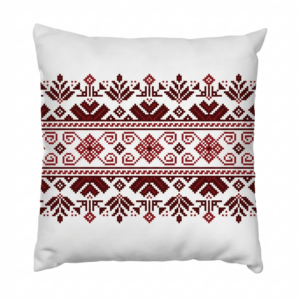 A single tribal medallion takes center stage on this natural ivory cushion — a compass-like cross of geometric motifs embroidered in terracotta, deep brown, and lilac. Understated in size, unforgettable in detail.